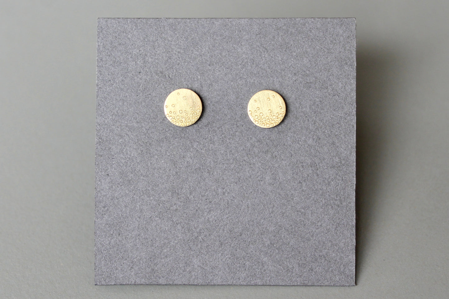 dainty golden ear studs with bubbles design
