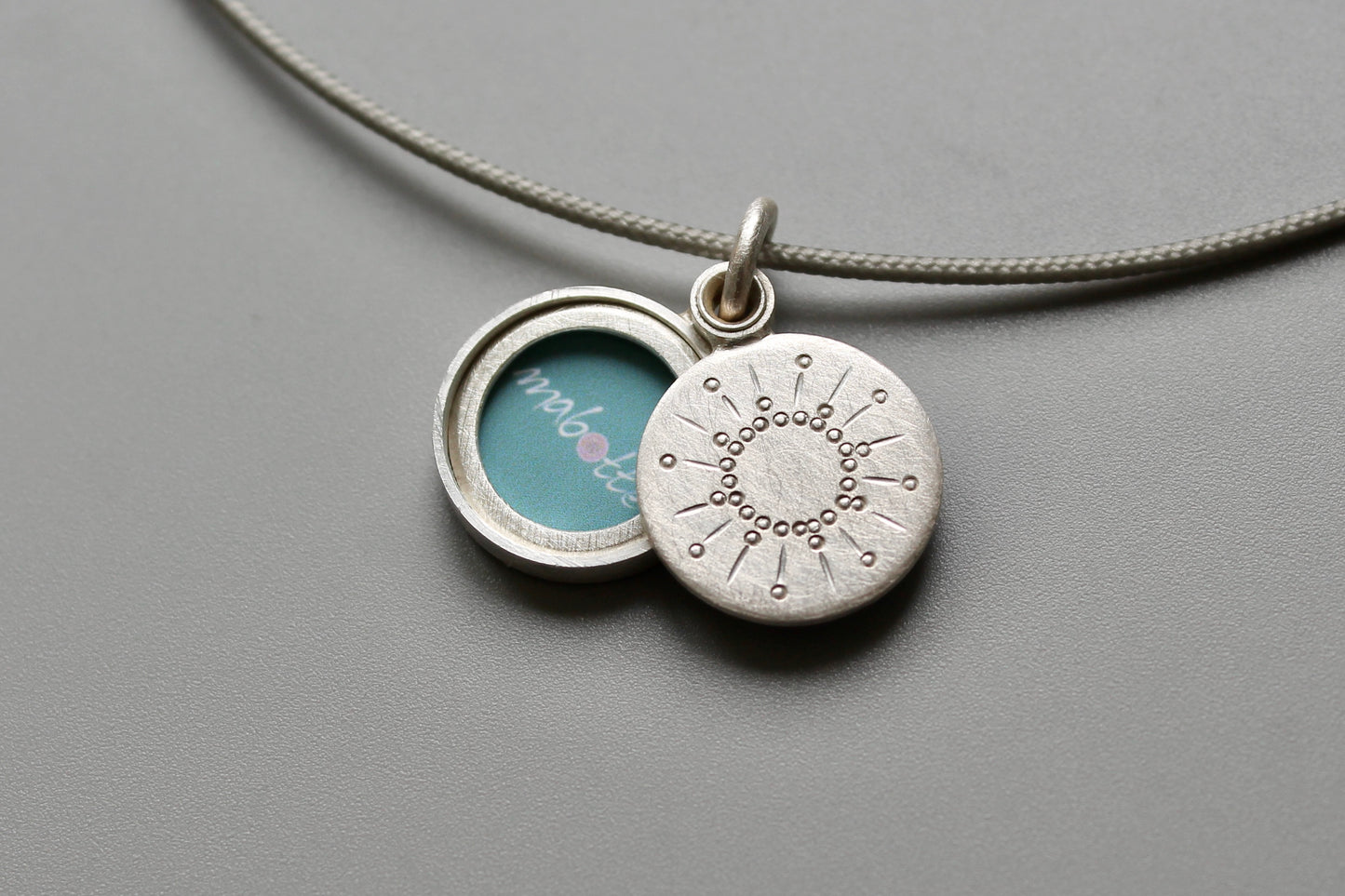 tiny silver picture locket with sun design
