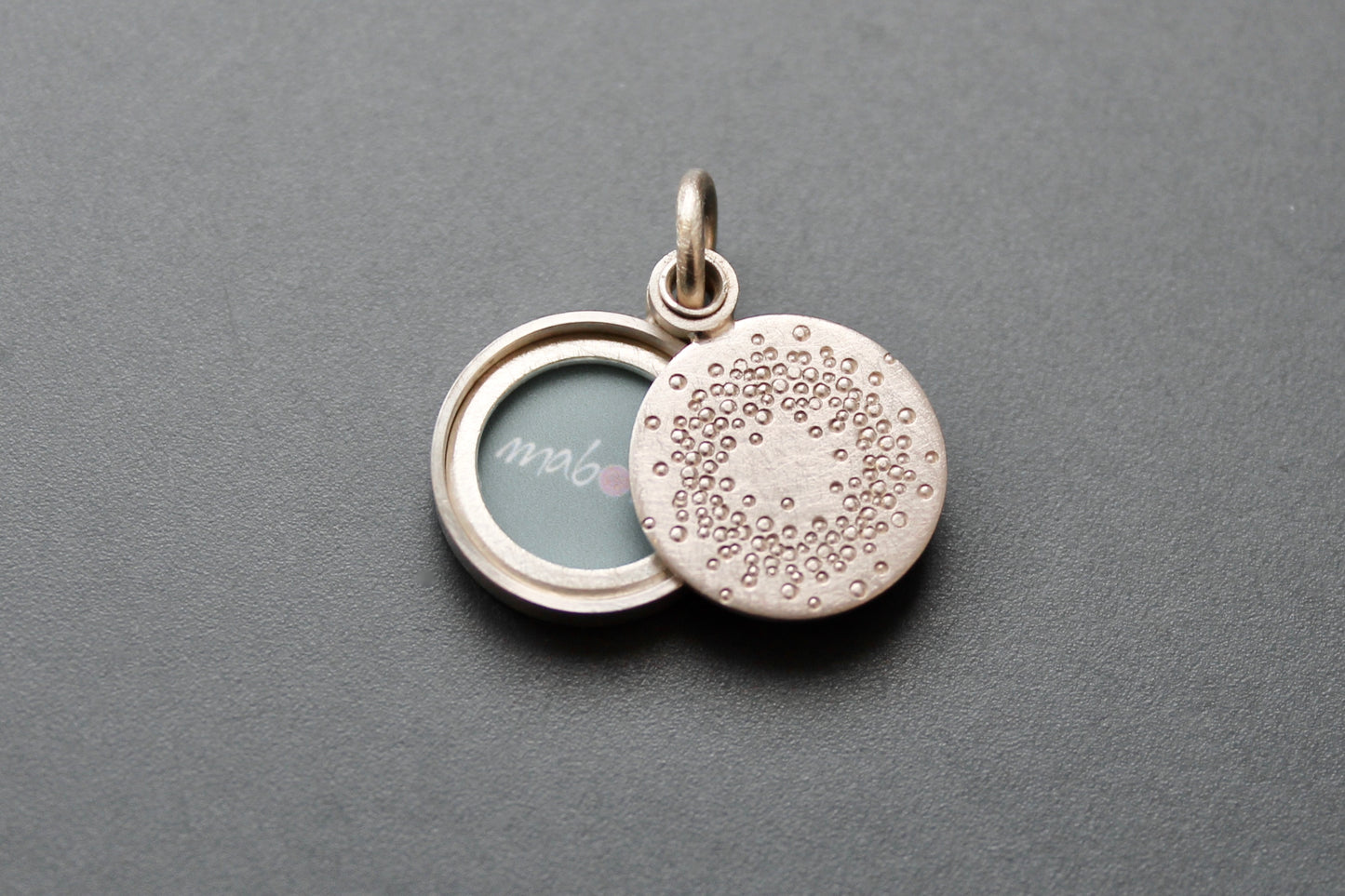 small mabotte locket for one photo in sterling silver with 1000 dots design