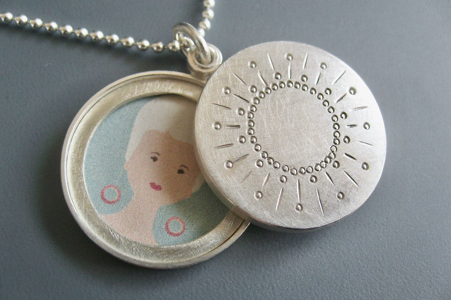 modern two photos locket with sun design in sterling silver