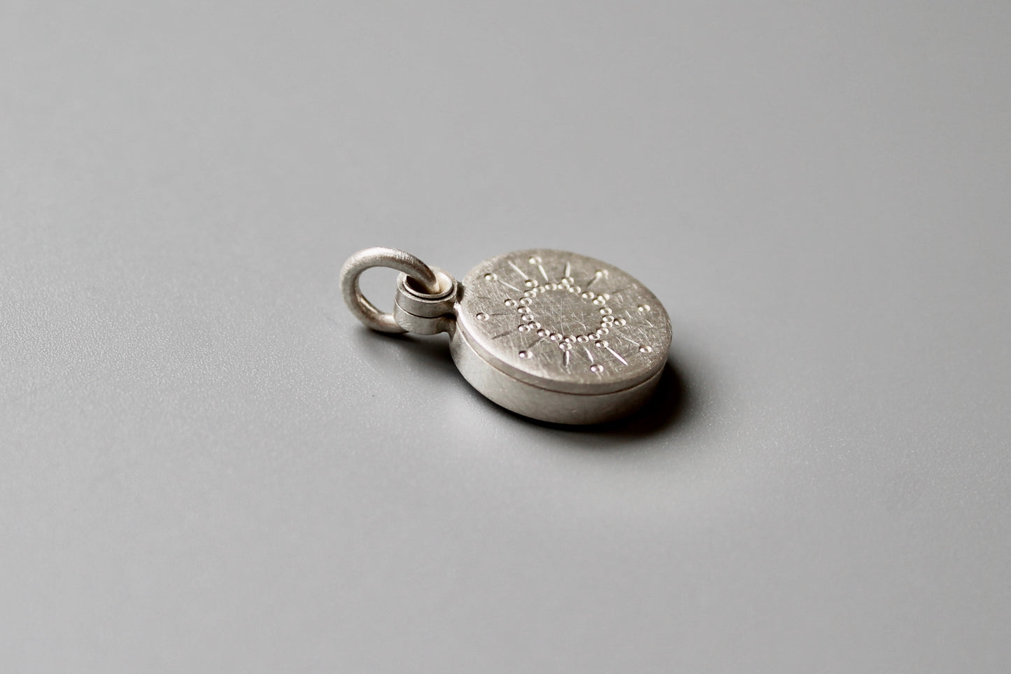 tiny silver picture locket with sun design