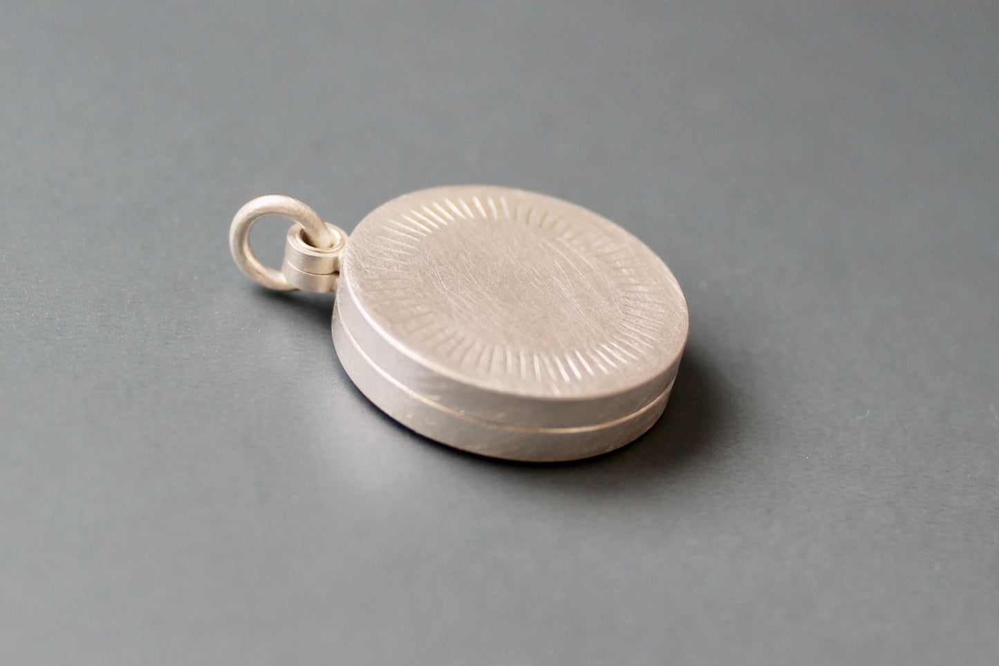 Minimalist silver locket for two pictures with aureole