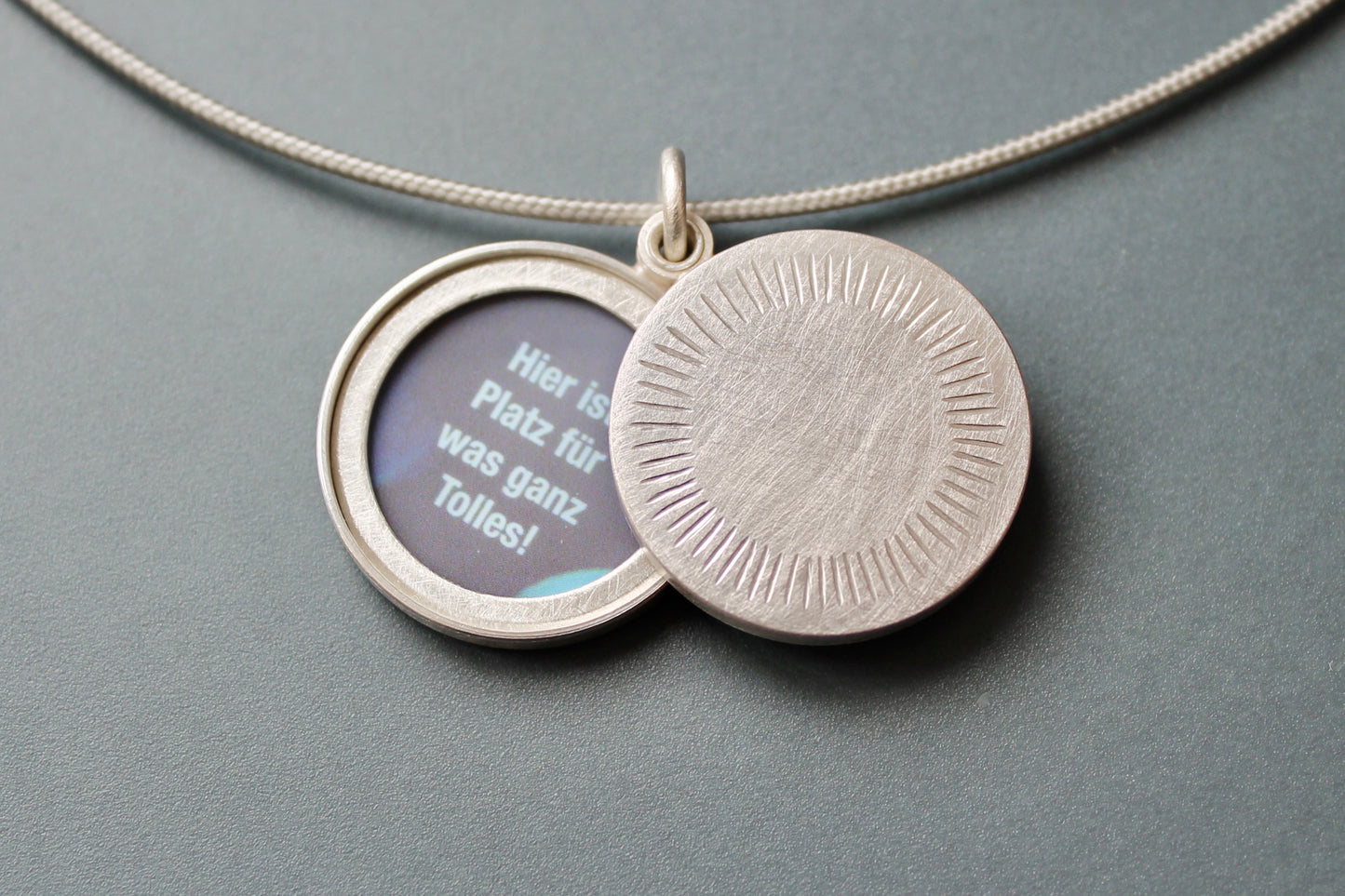 Minimalist silver locket for two pictures with aureole