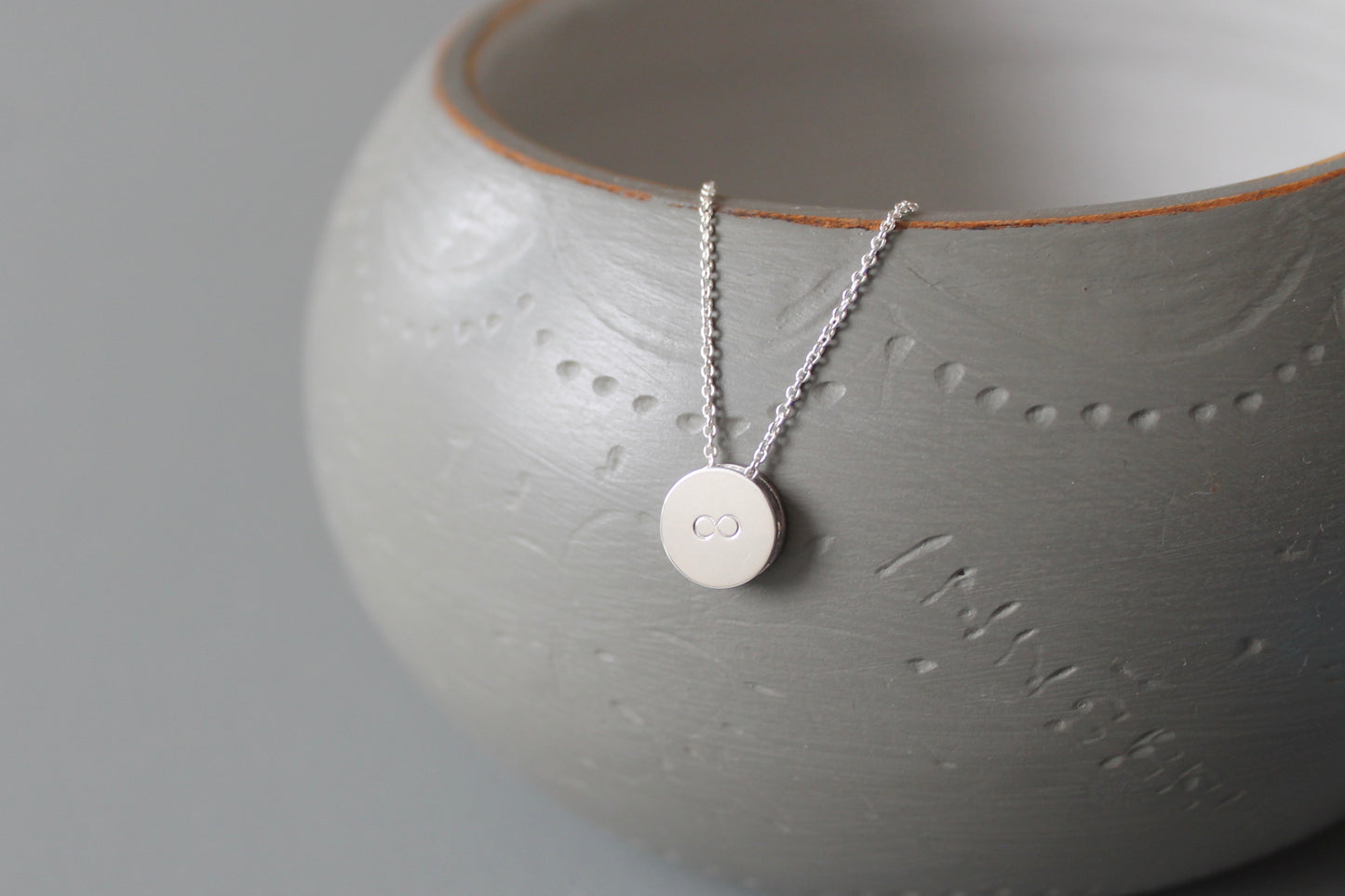 tiny pendant necklace in sterling silver with infinity symbol