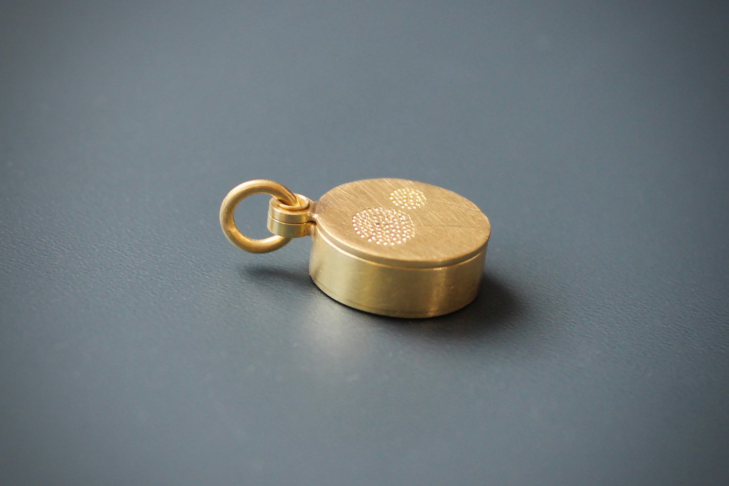 golden dandelion locket filled with forget me not seeds