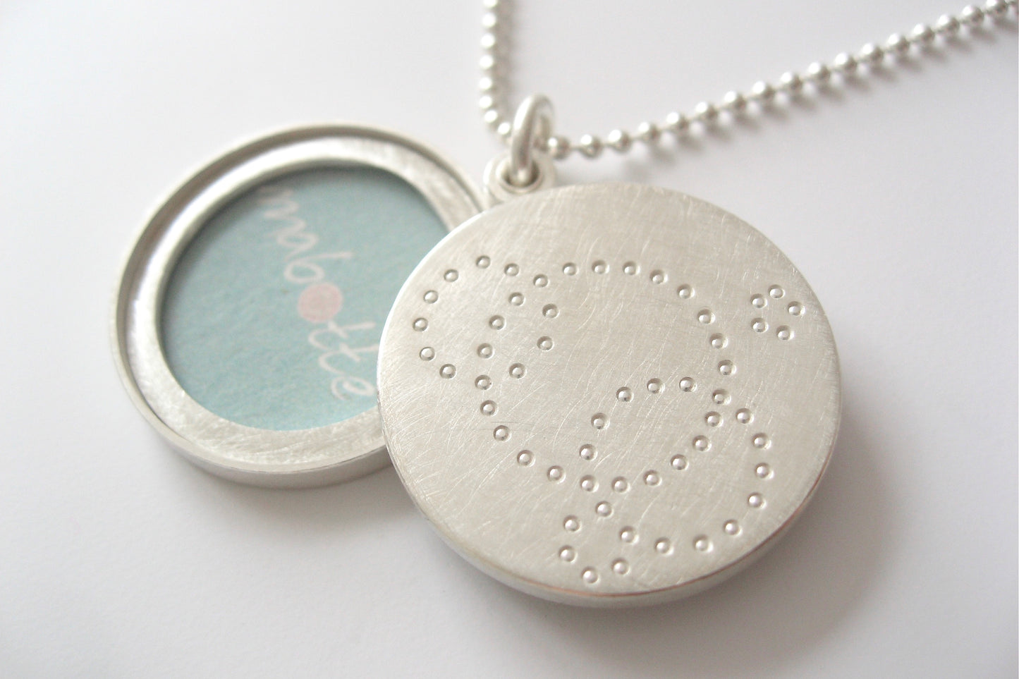 contemporary locket for two pictures handmade in sterling silver