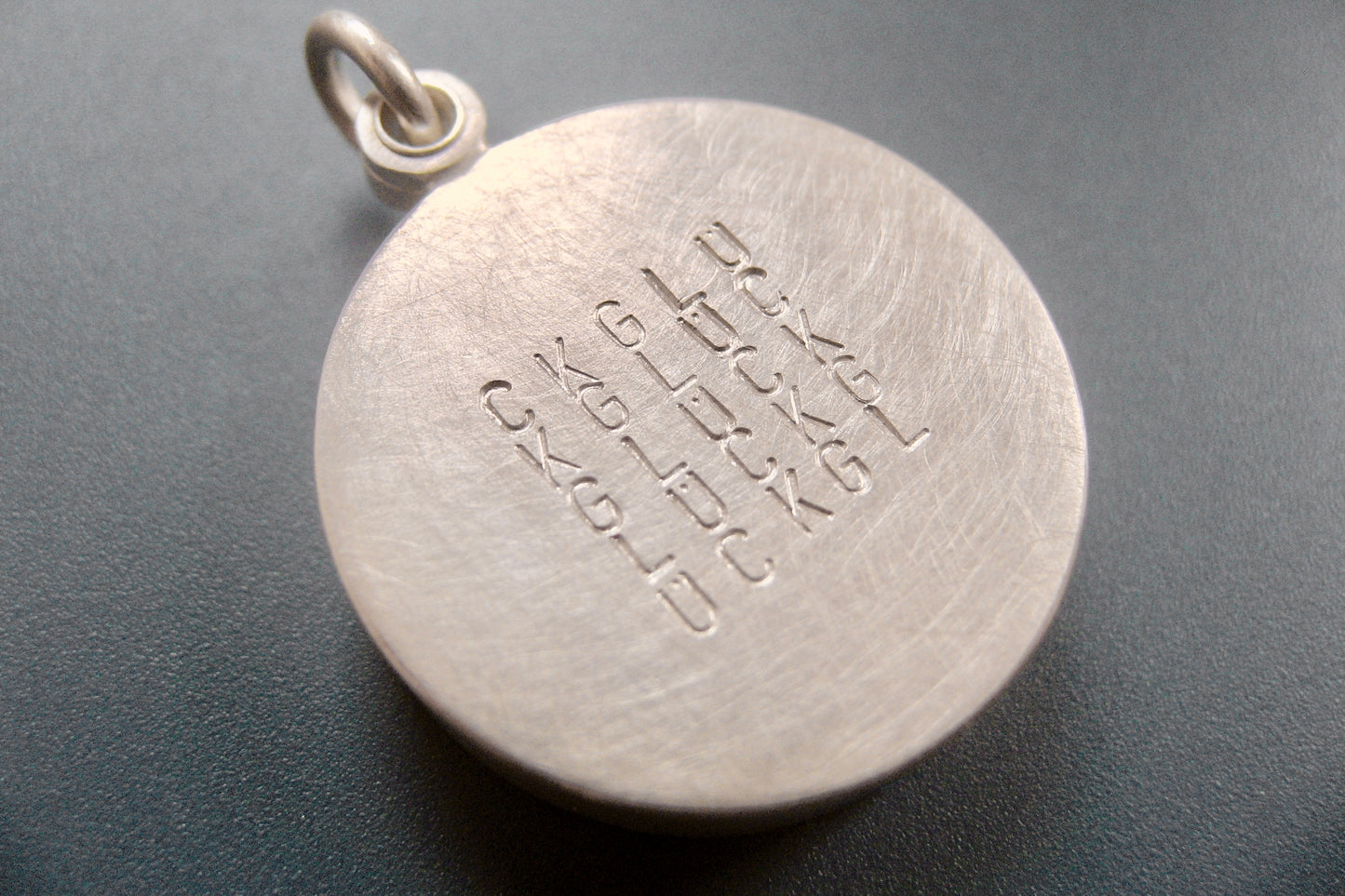 custom glass locket with floating name plates in sterling silver with typographic design