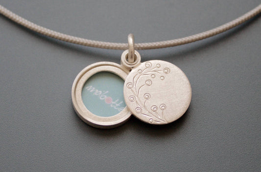 dainty round photo pendant with delicate twig in sterling silver