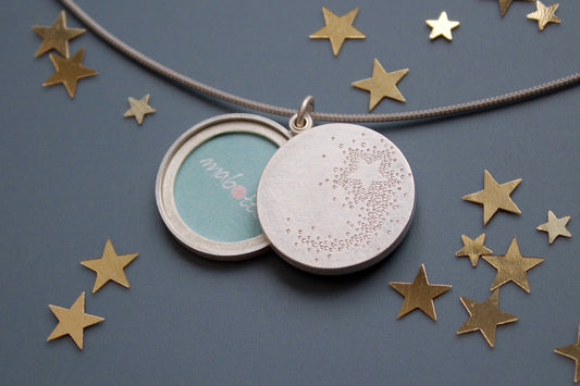 wish locket for two photos with shooting star design in sterling silver