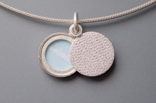 minimalist modern locket for a small photo in structured sterling silver