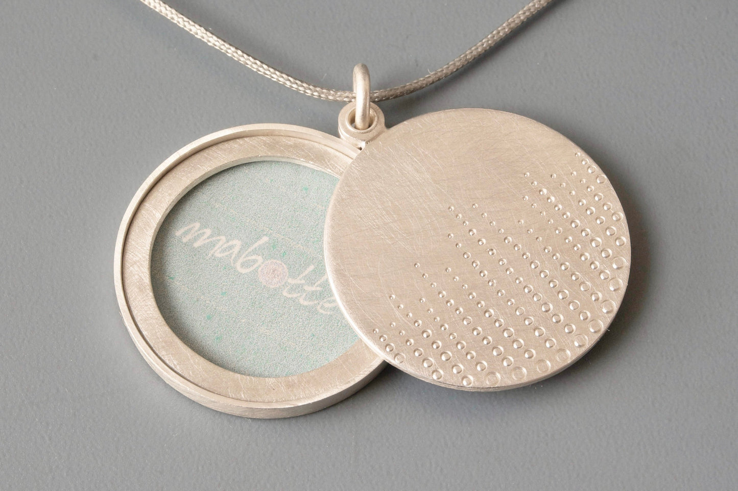 round sterling silver photo locket with drops of dew design