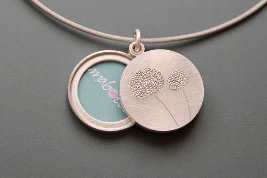 mabotte double locket with delicate dandelions in sterling silver