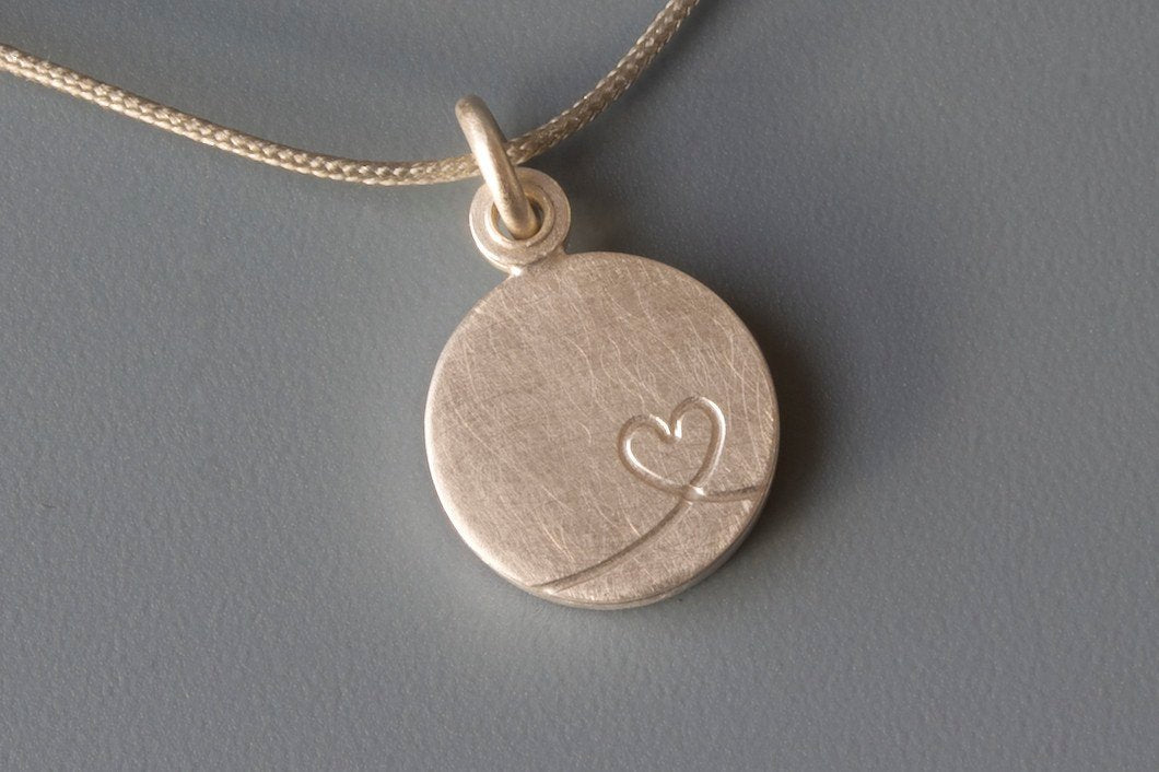 charming silver photo locket with little heart design
