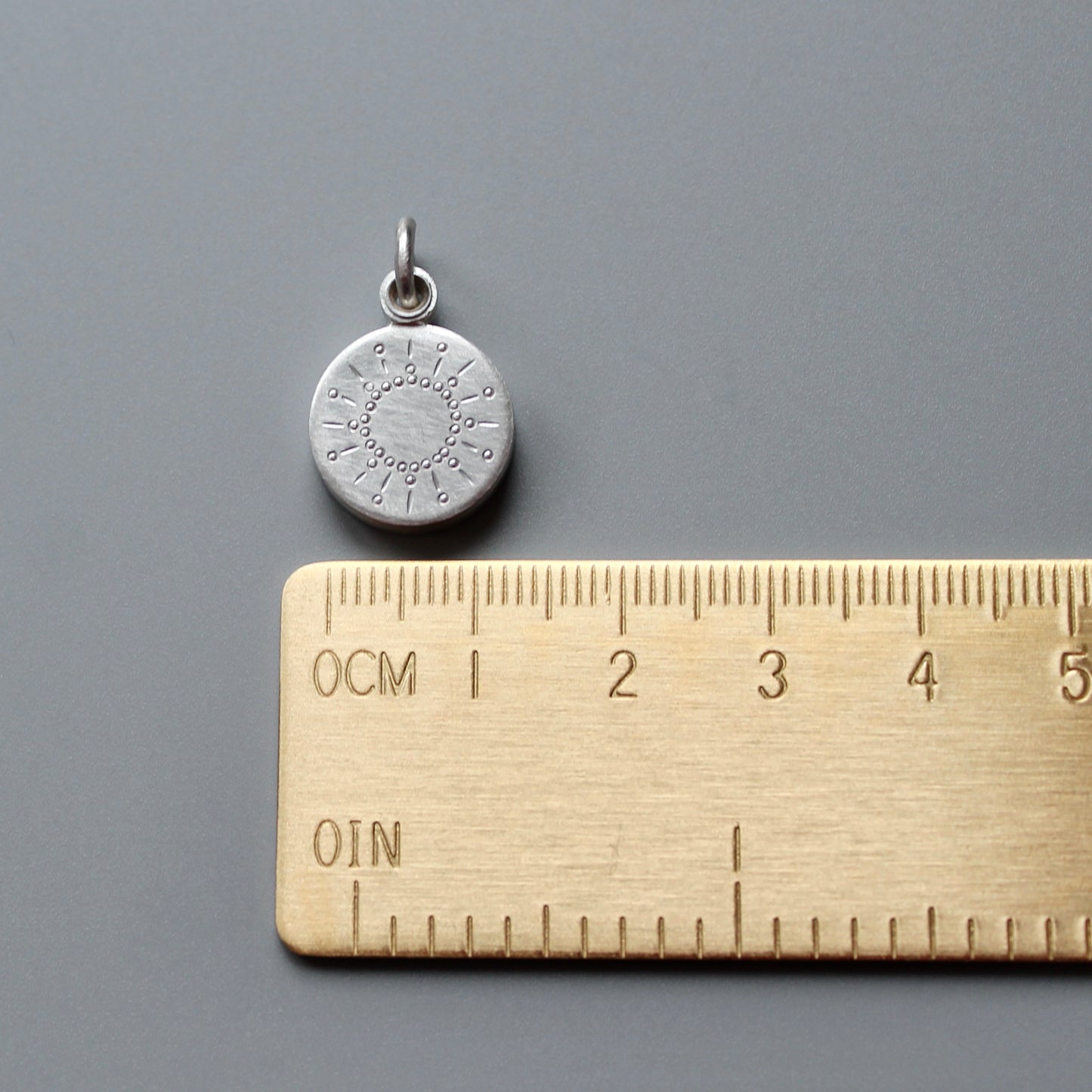 tiny silver picture locket with sun design