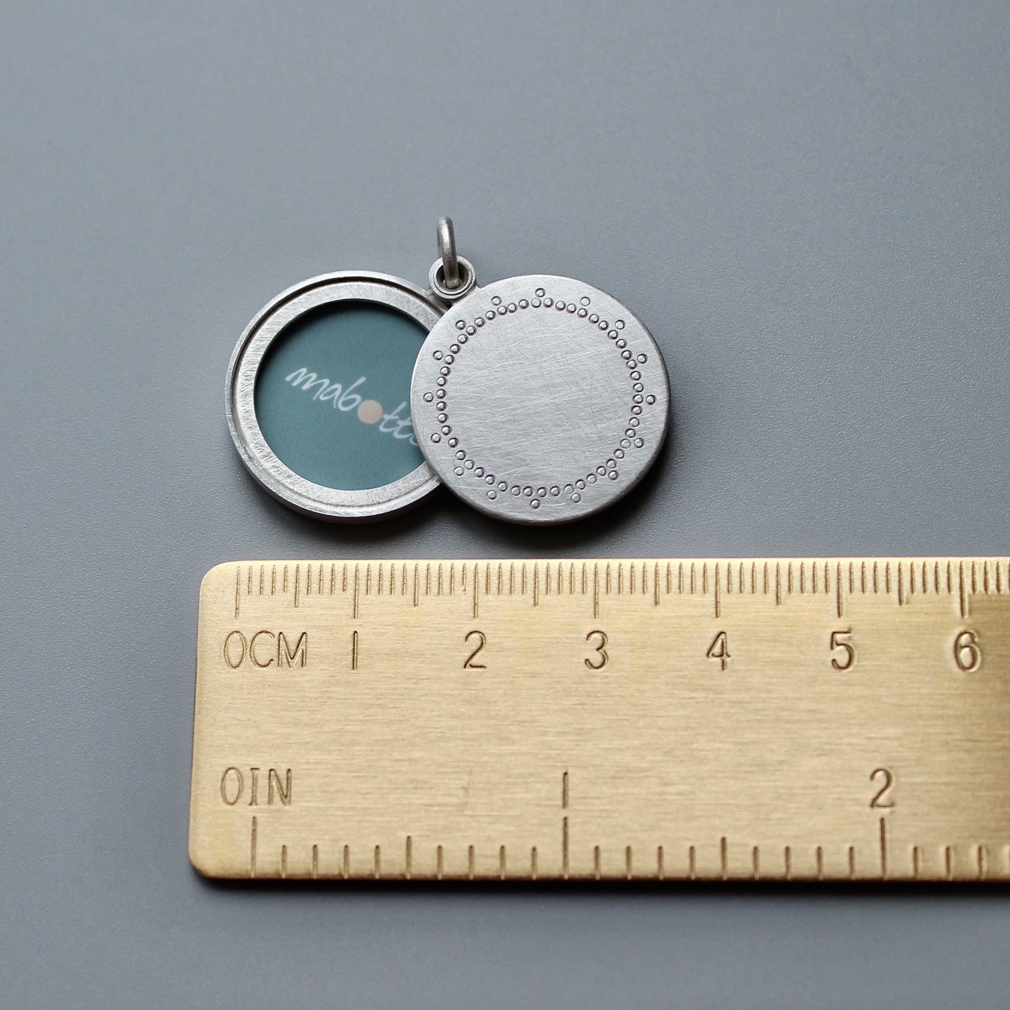 modern silver photo locket with delicate lace pattern