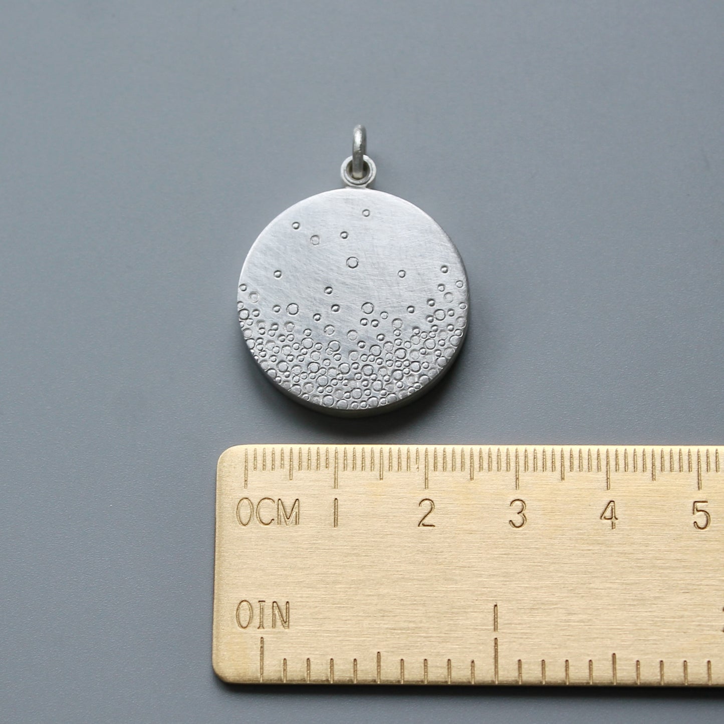 modern photo locket in sterling silver with bubbles design