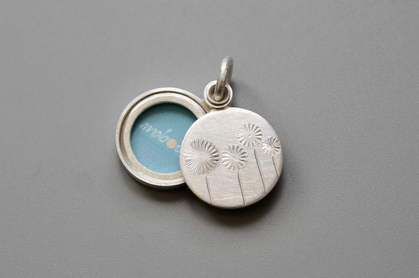 small locket with four dandelions for one photo handmade in sterling silver