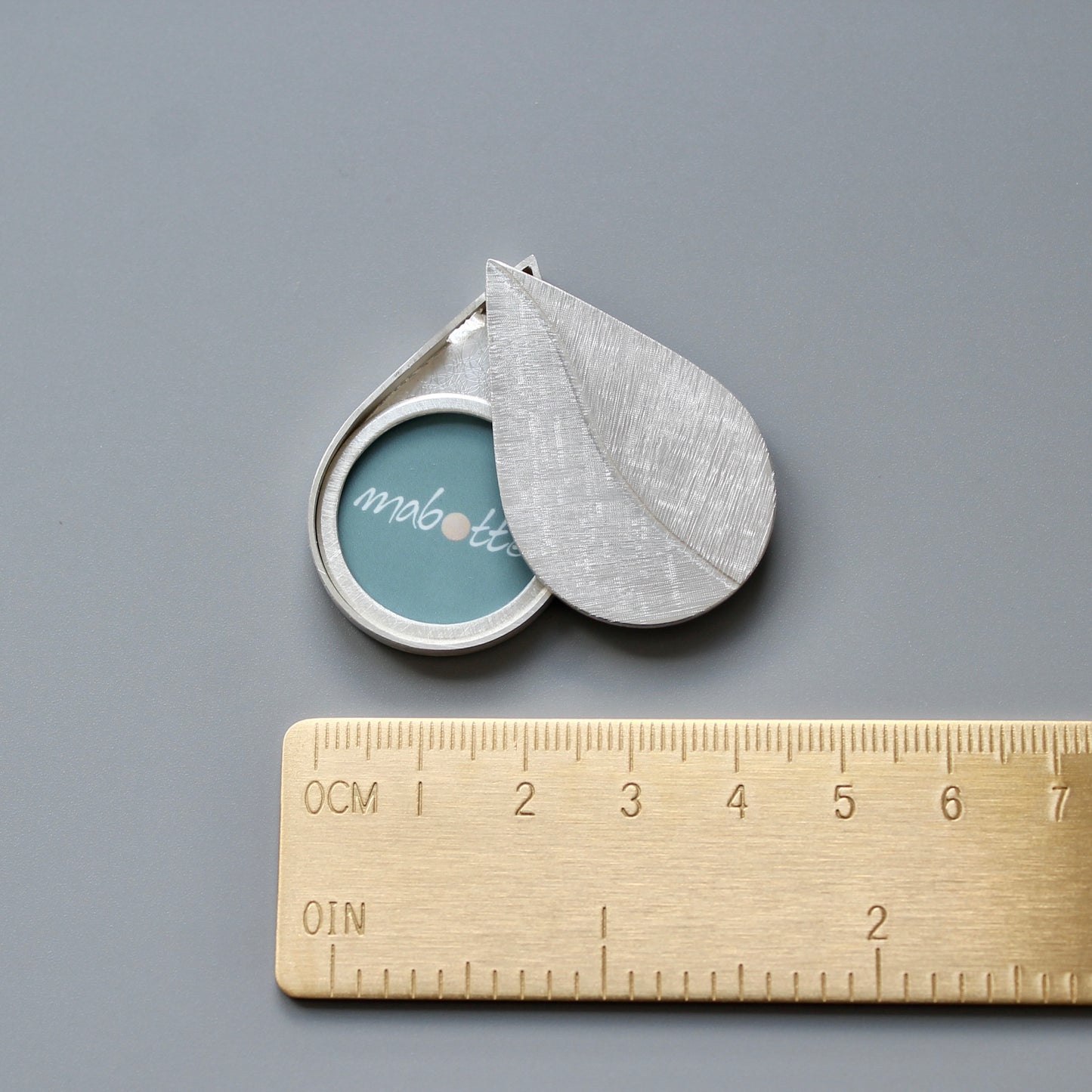 large drop shaped picture locket installing silver with leaf design