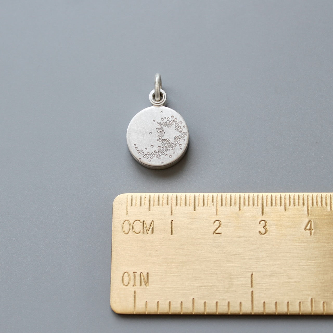 tiny sterling silver photo locket with a shooting star