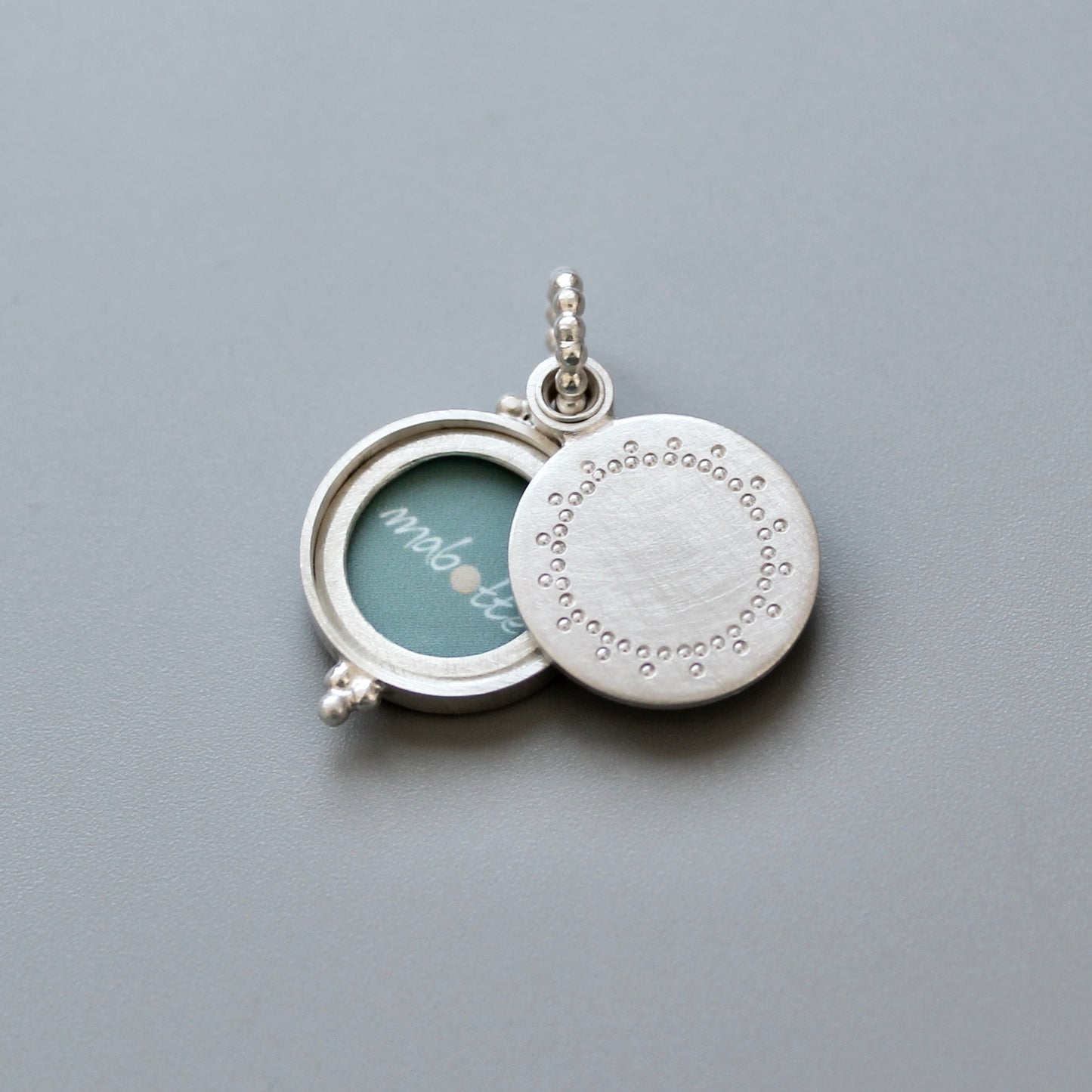 small silver photo locket with dainty lace design