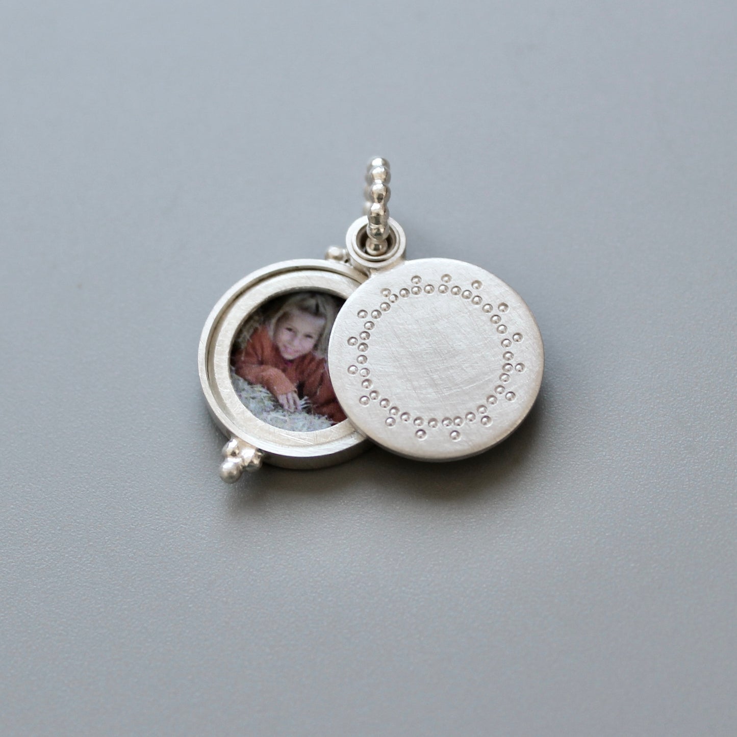 small silver photo locket with dainty lace design