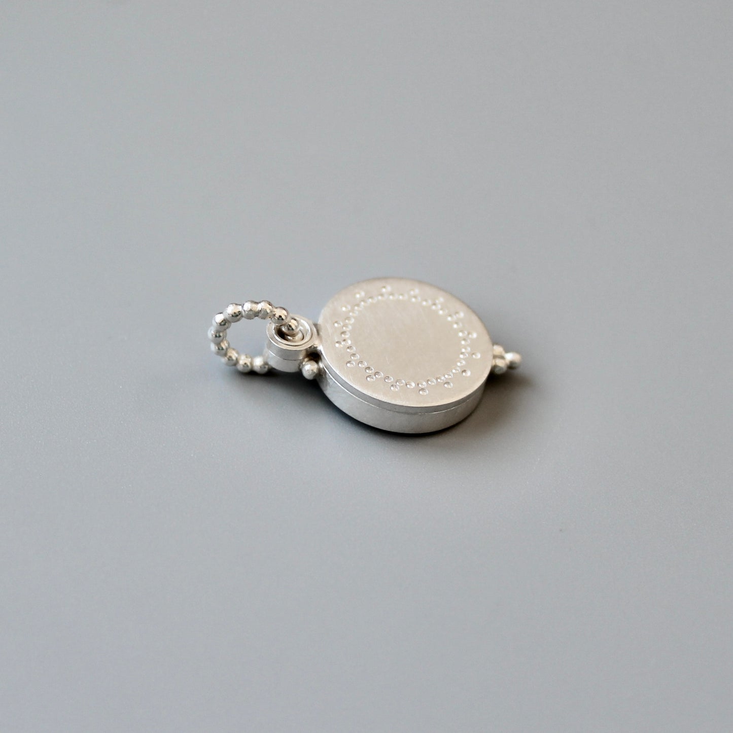 small silver photo locket with dainty lace design