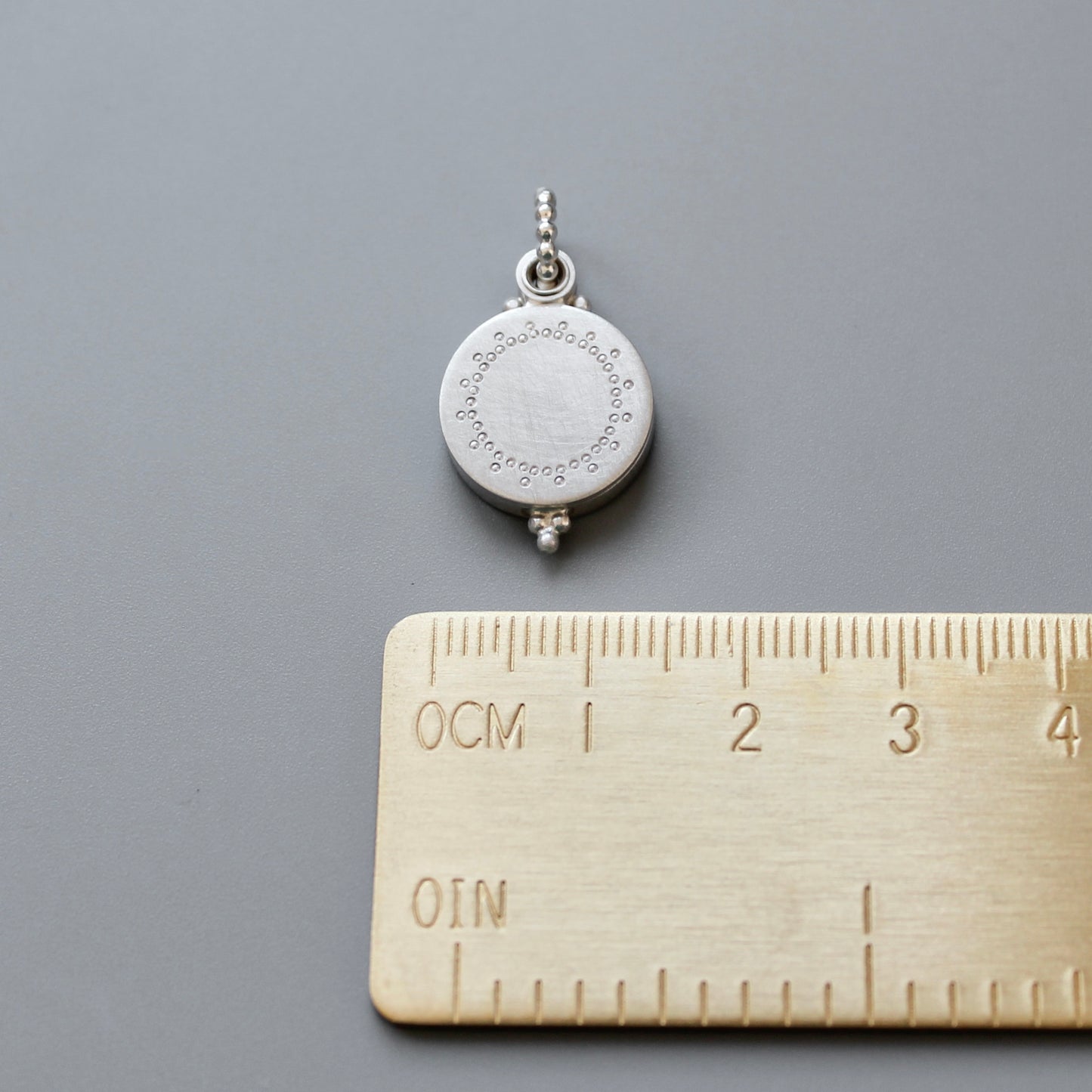 small silver photo locket with dainty lace design