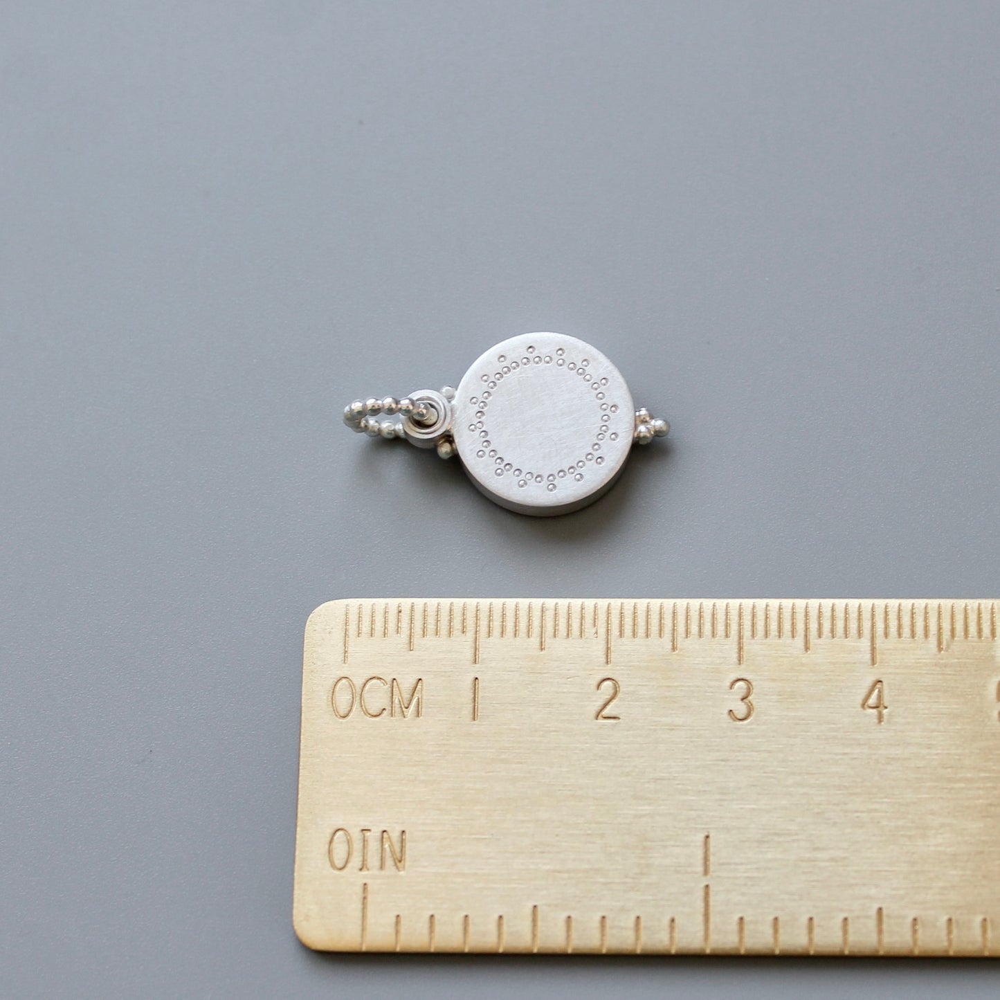 small silver photo locket with dainty lace design