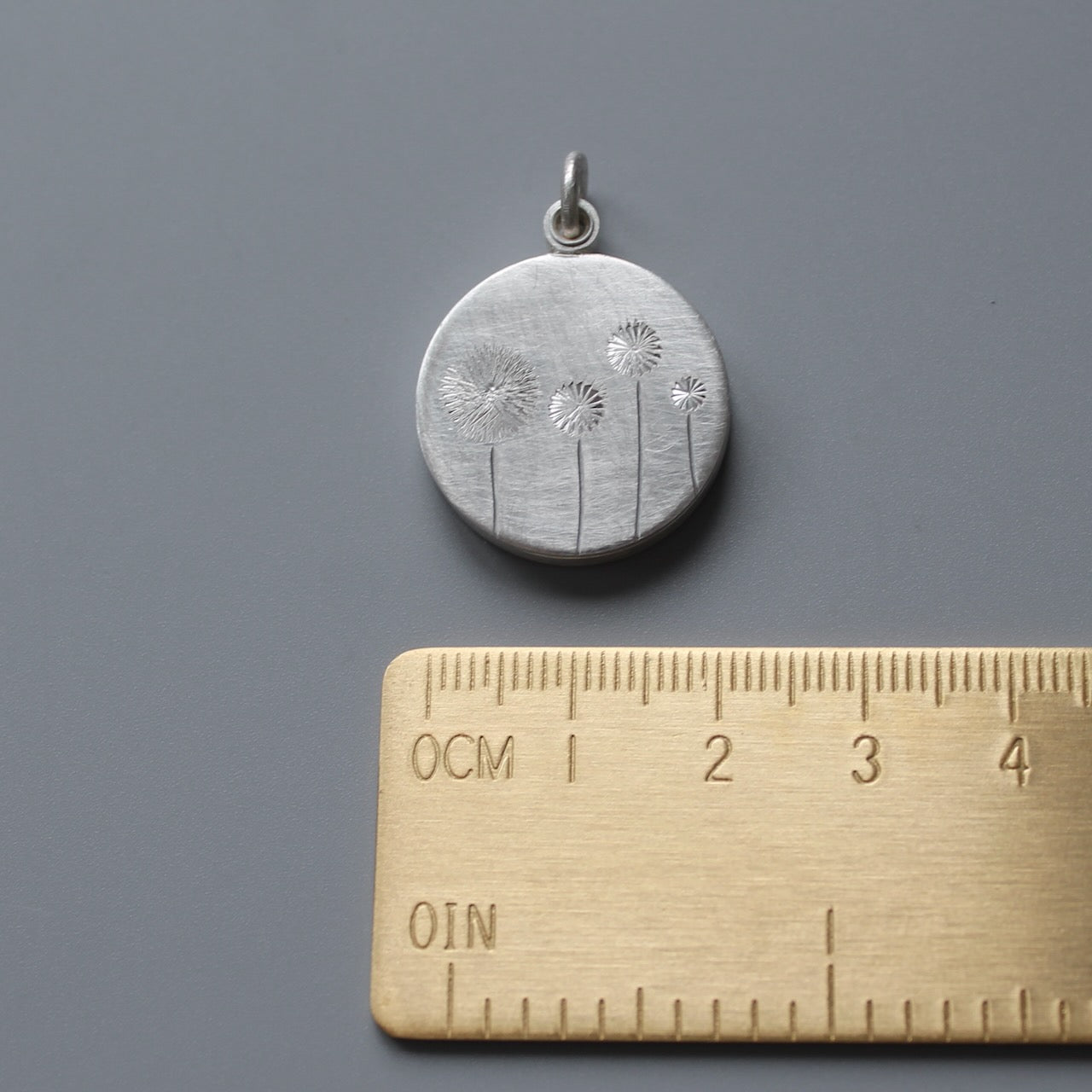 sterling silver floating dandelion locket filled with stamped letter plates