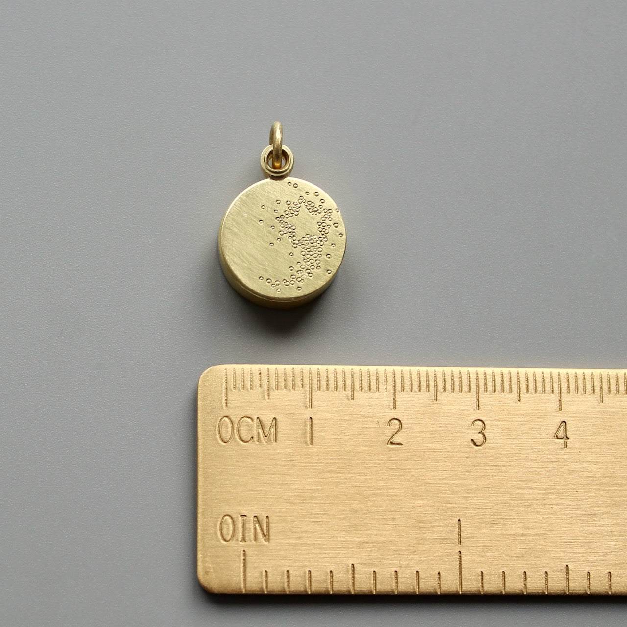 golden floating locket with shooting star