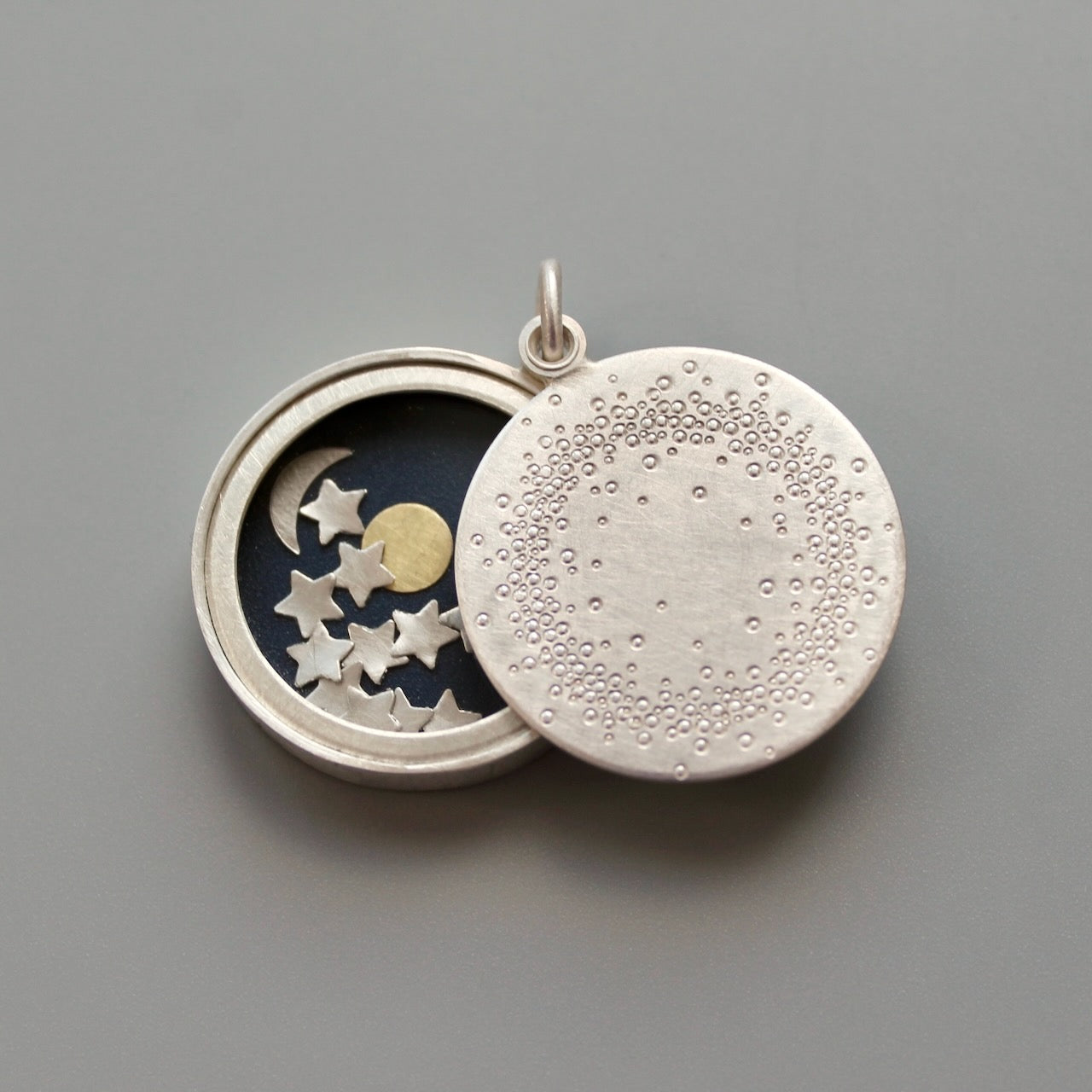 unique sterling silver glass locket filled with sun moon and stars