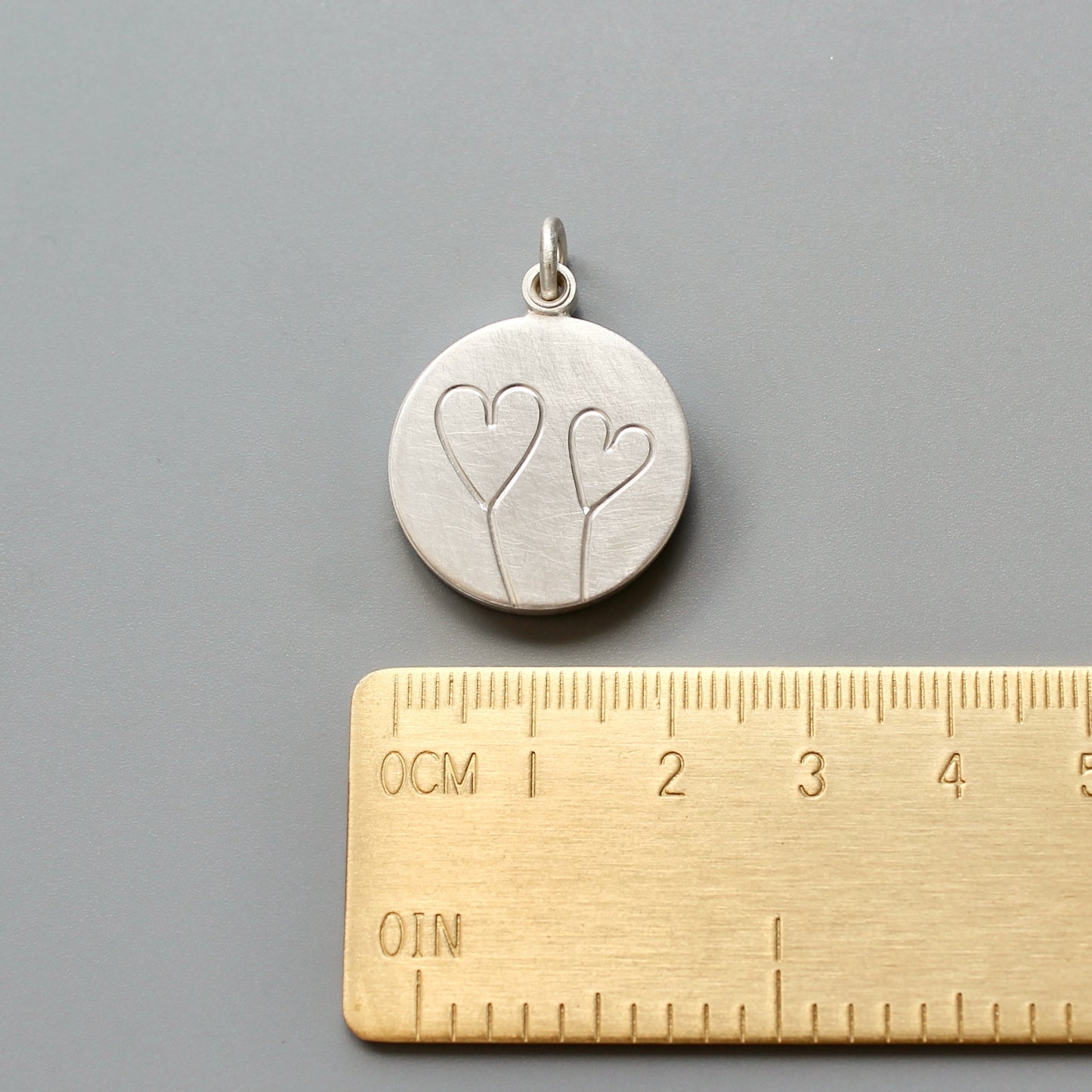 romantic silver photo locket with symbolic two hearts design
