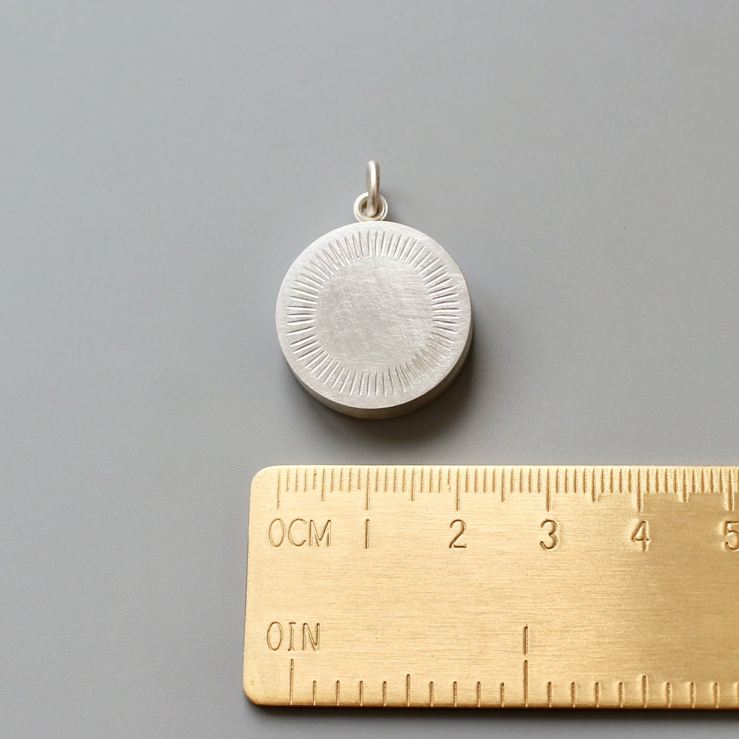 Minimalist silver locket for two pictures with aureole