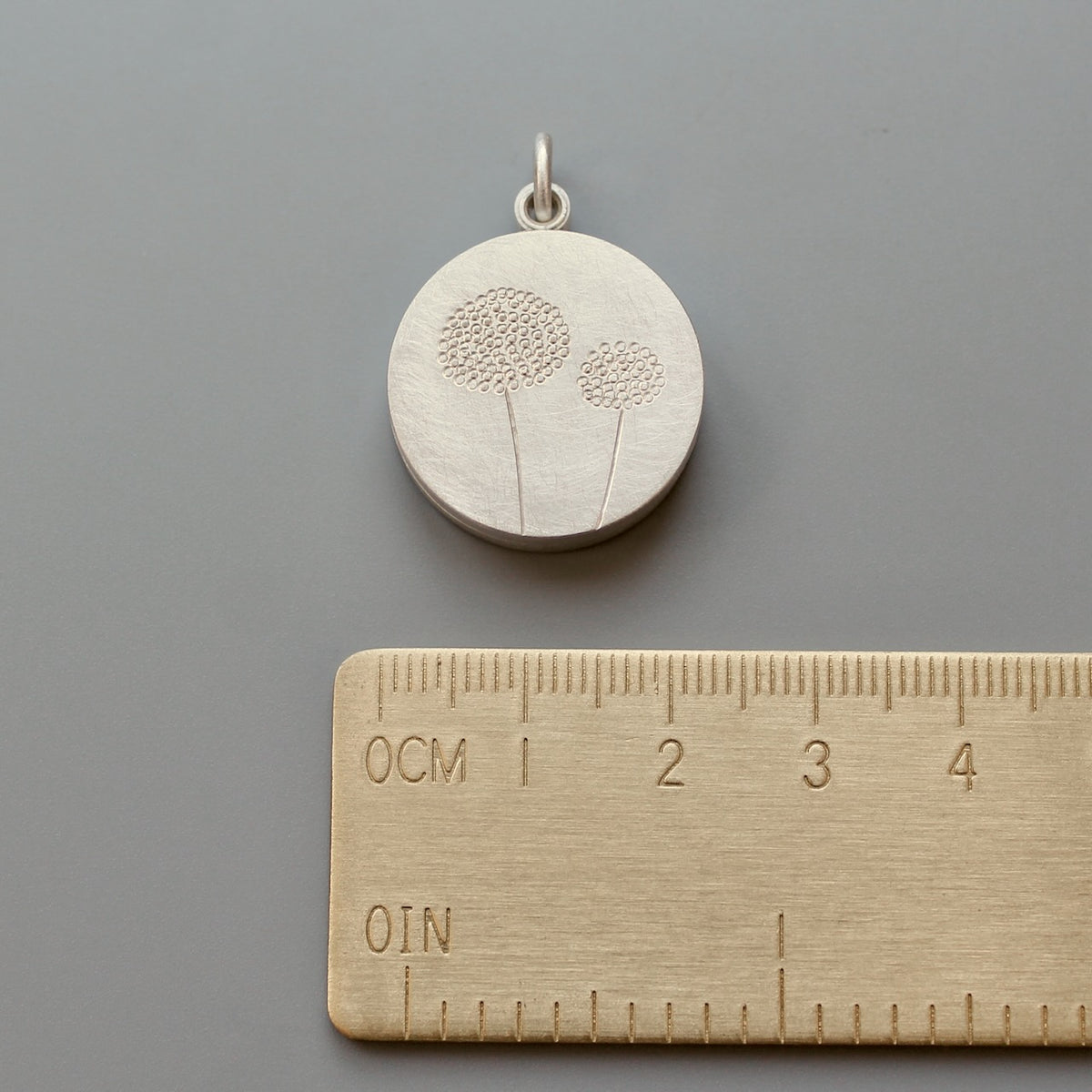 mabotte double locket with delicate dandelions in sterling silver