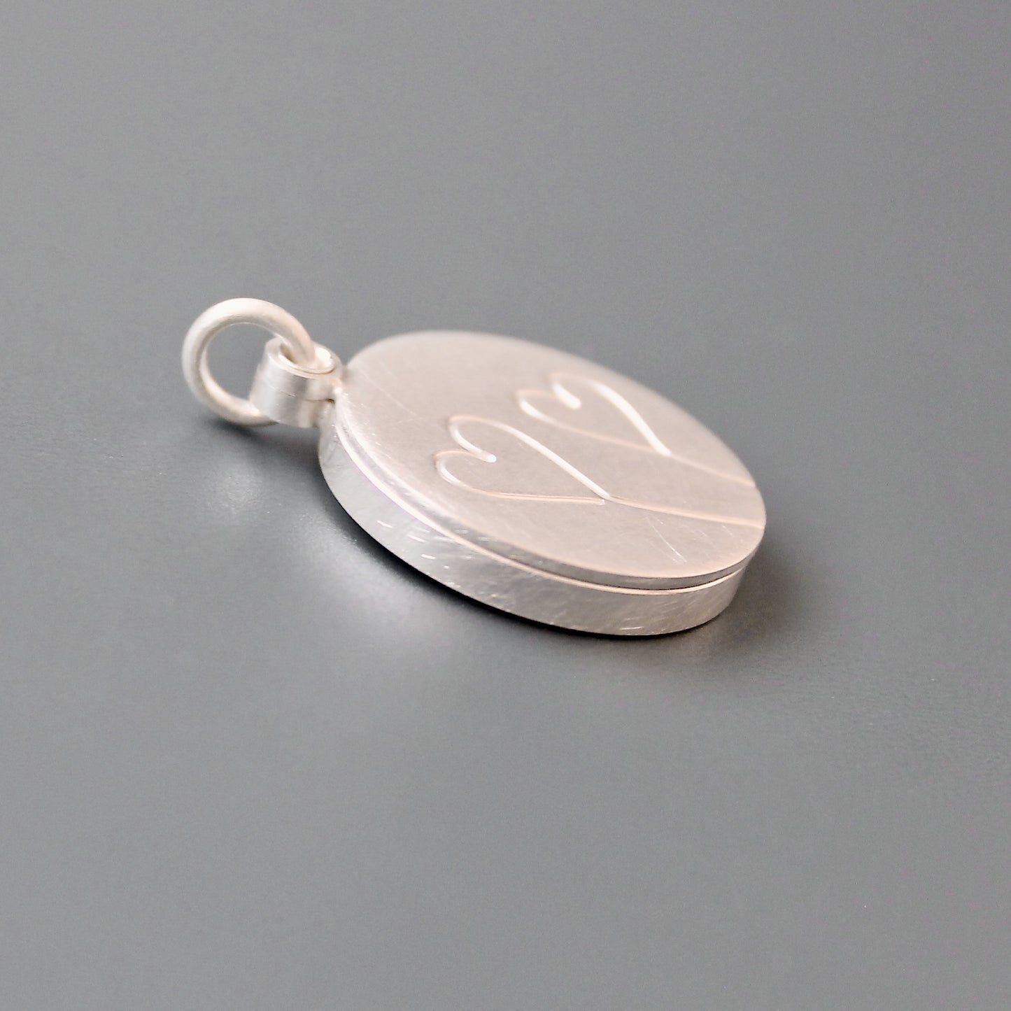 romantic silver photo locket with symbolic two hearts design