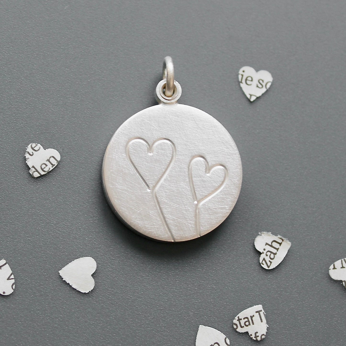 romantic silver photo locket with symbolic two hearts design