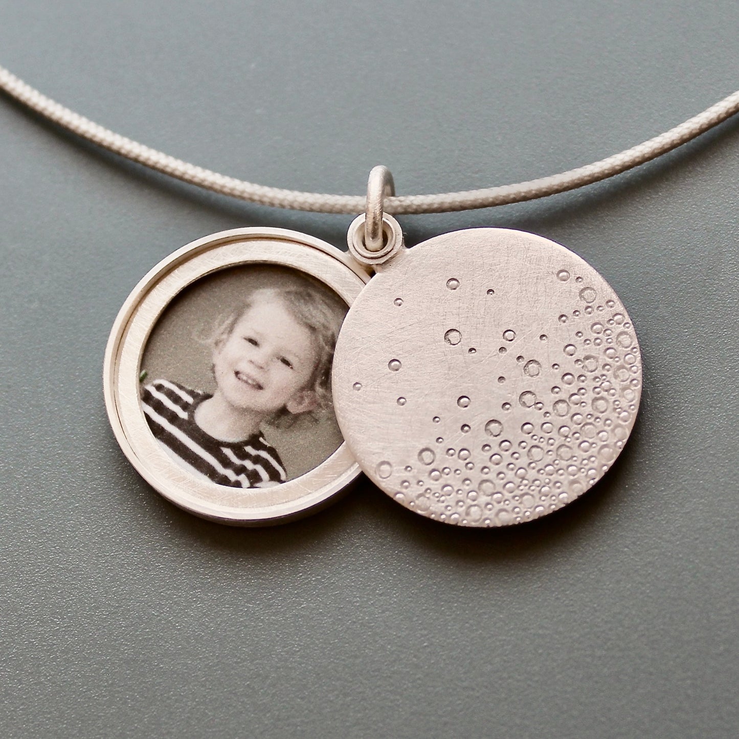 modern photo locket in sterling silver with bubbles design