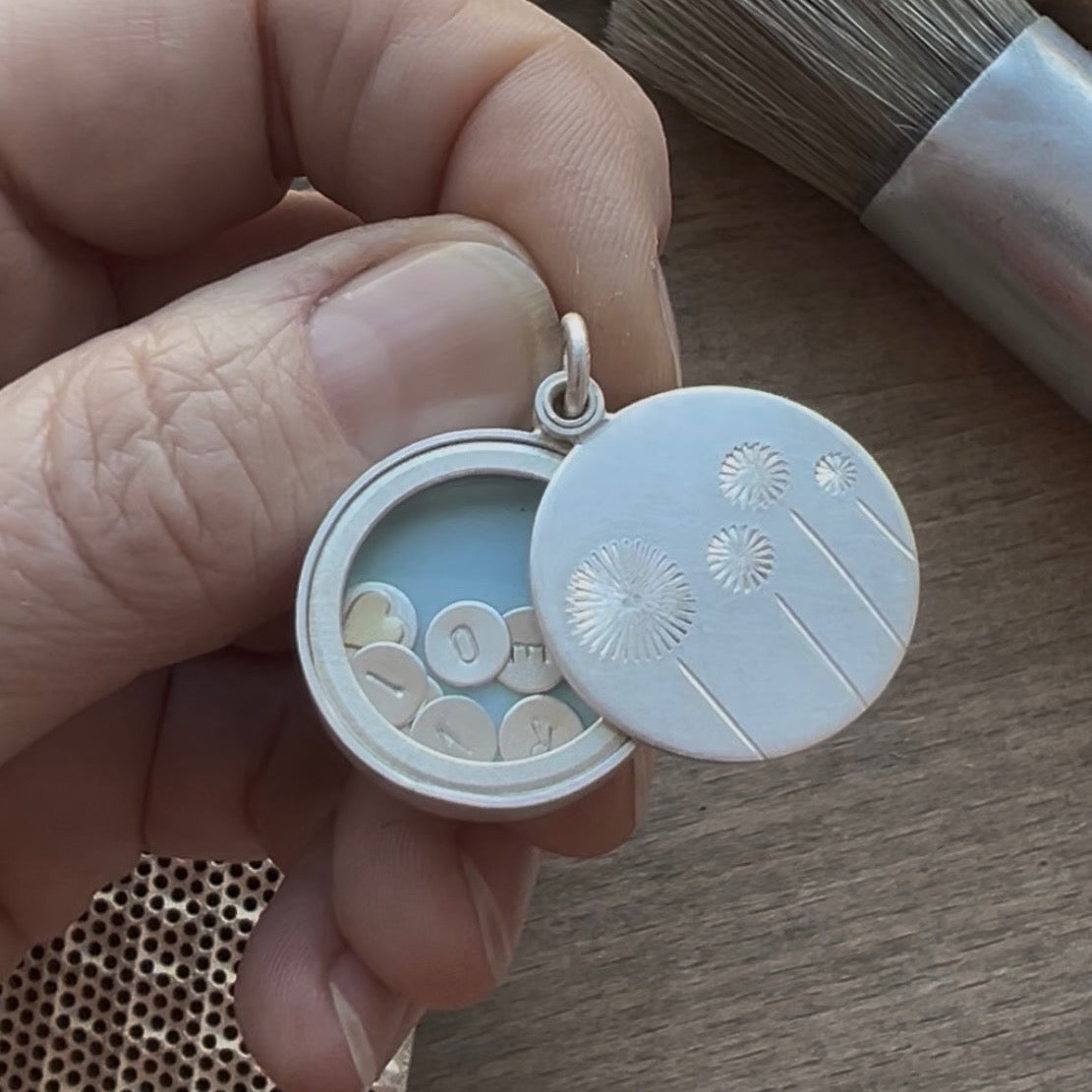 sterling silver floating dandelion locket filled with stamped letter plates