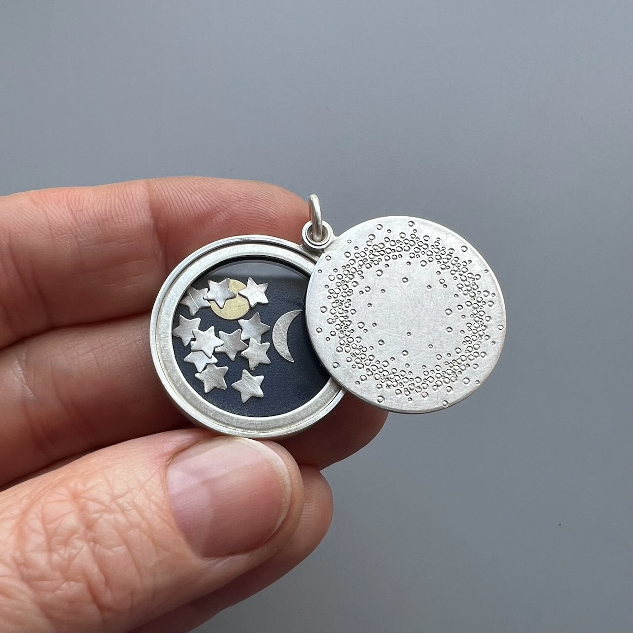 unique sterling silver glass locket filled with sun moon and stars