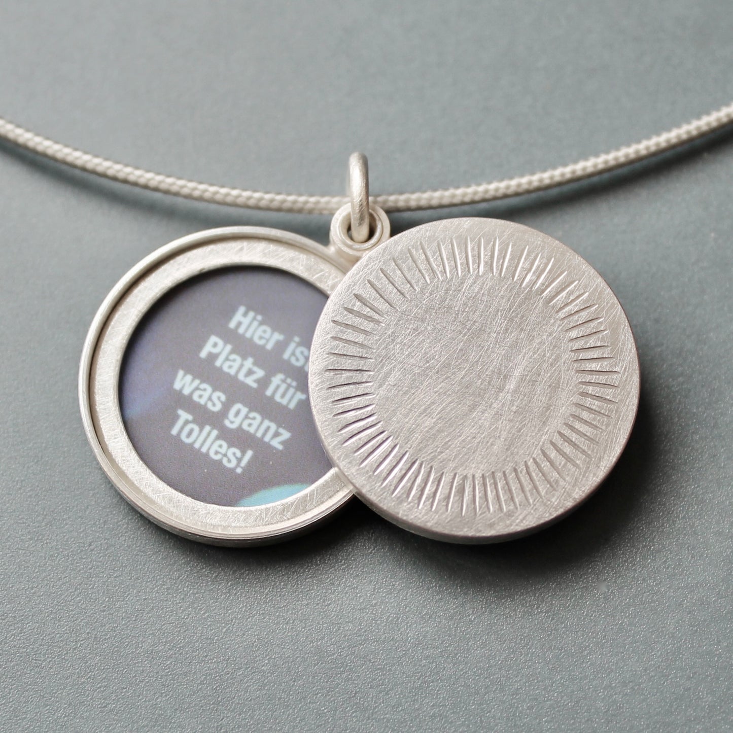 Minimalist silver locket for two pictures with aureole