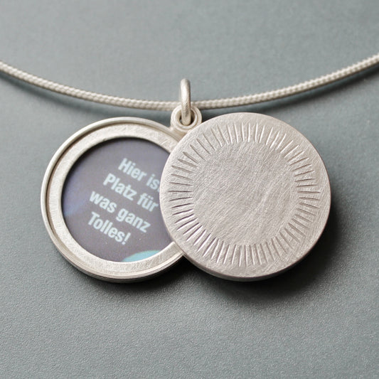 Minimalist silver locket for two pictures with aureole