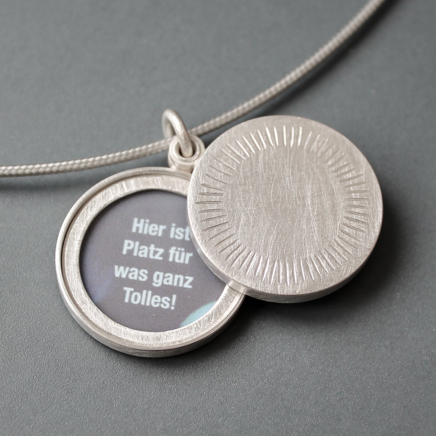Minimalist silver locket for two pictures with aureole
