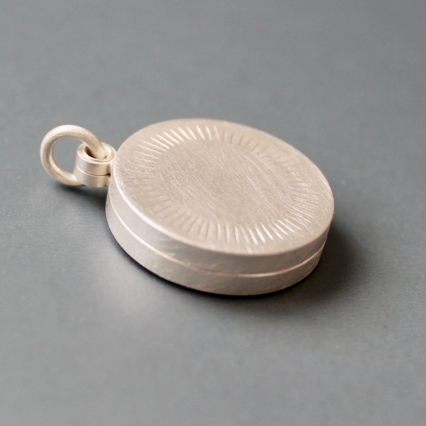 Minimalist silver locket for two pictures with aureole