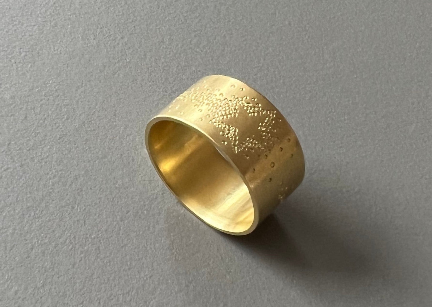 wide golden band ring with shooting star design
