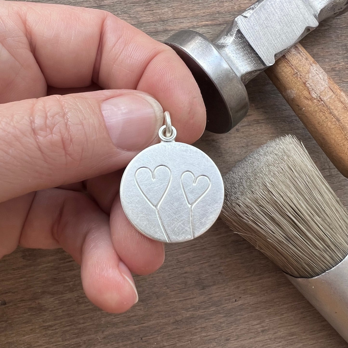 romantic silver photo locket with symbolic two hearts design