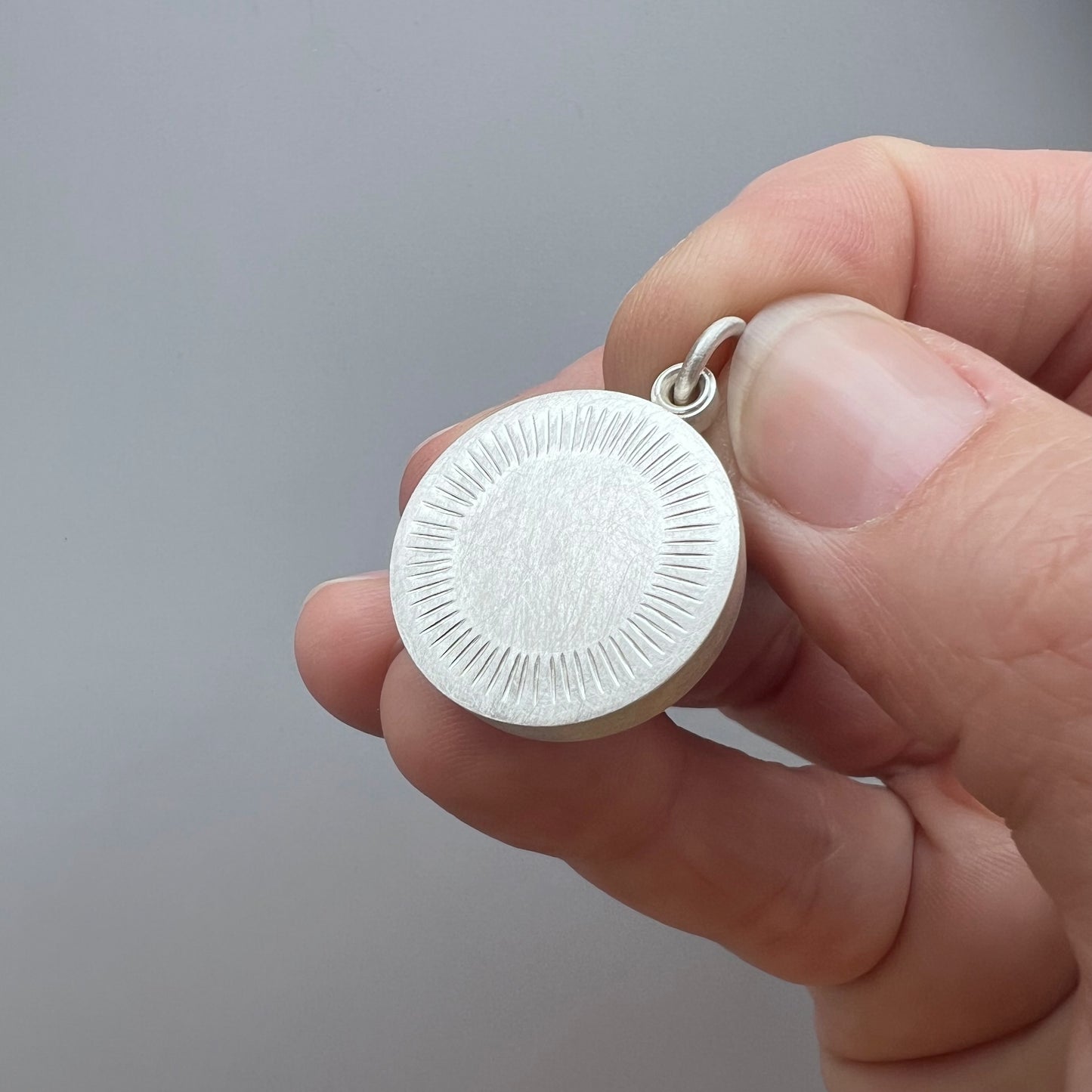 Minimalist silver locket for two pictures with aureole