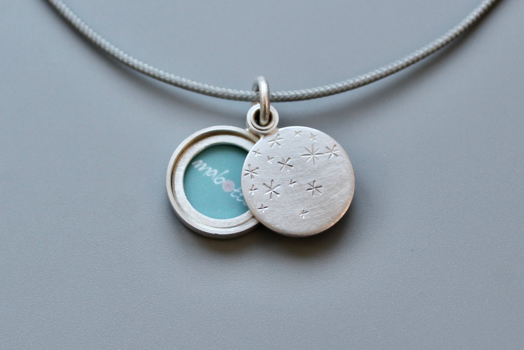 small locket with starry night design in sterling silver