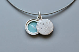 small locket with starry night design in sterling silver