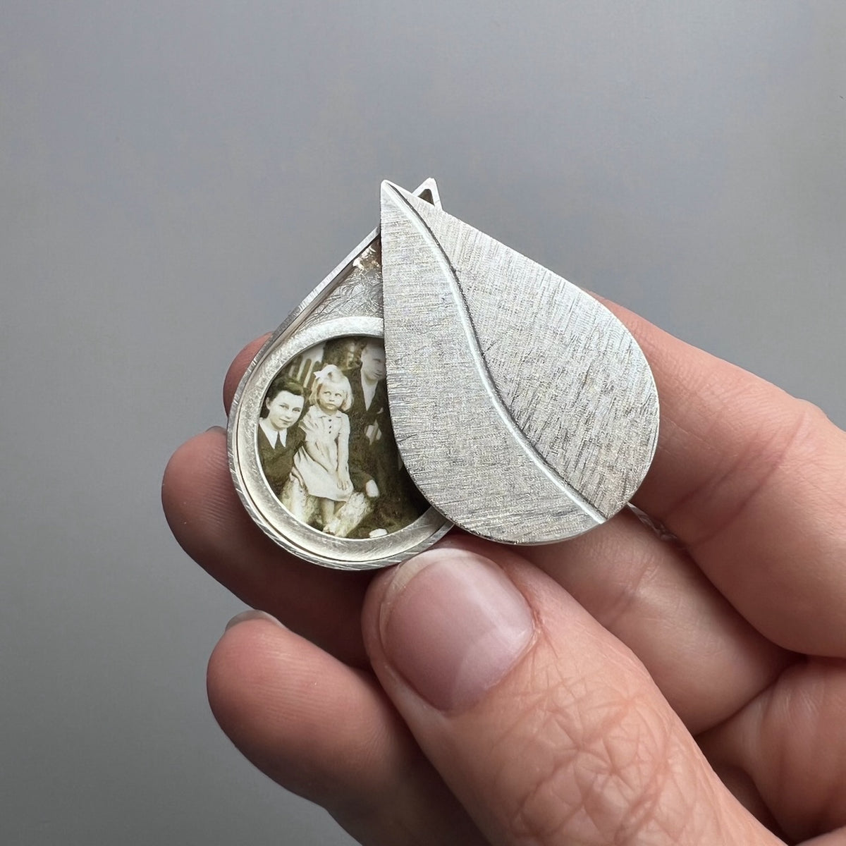 large drop shaped picture locket installing silver with leaf design