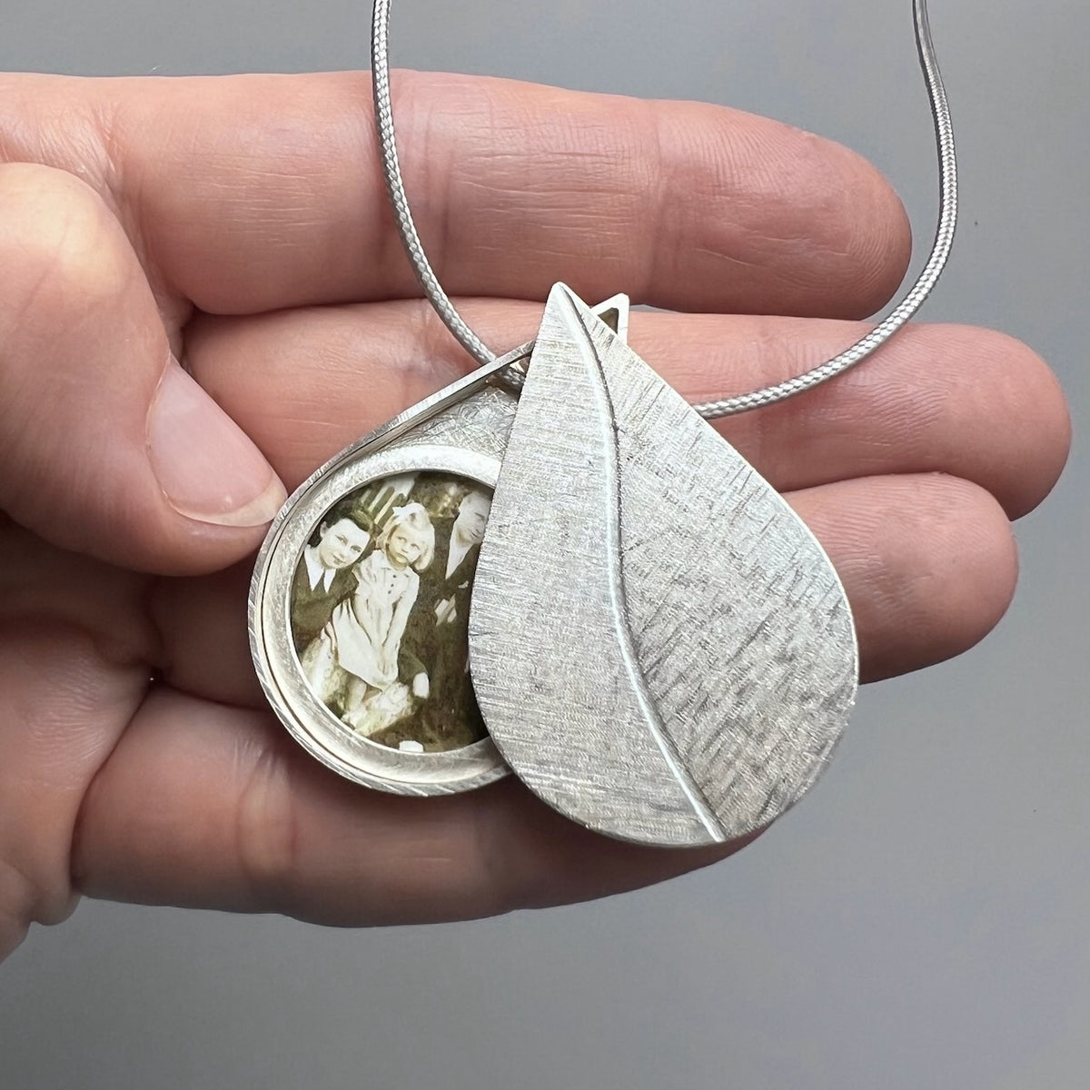 large drop shaped picture locket installing silver with leaf design